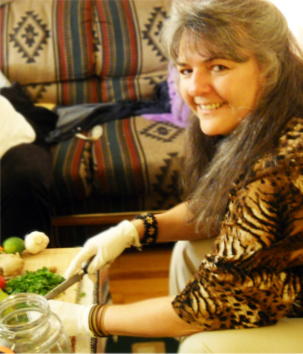 Lori chopping herbs at the table